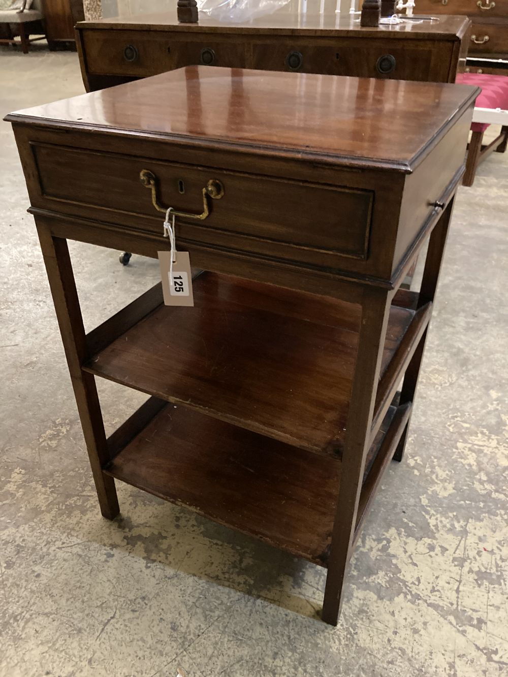 A George III style mahogany three tier table, fitted single drawer, width 47cm depth 41cm height 71cm